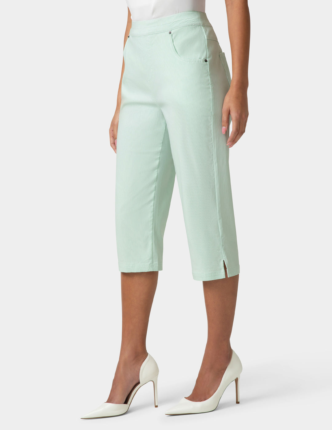 Light green capri pants worn by a person on a white background