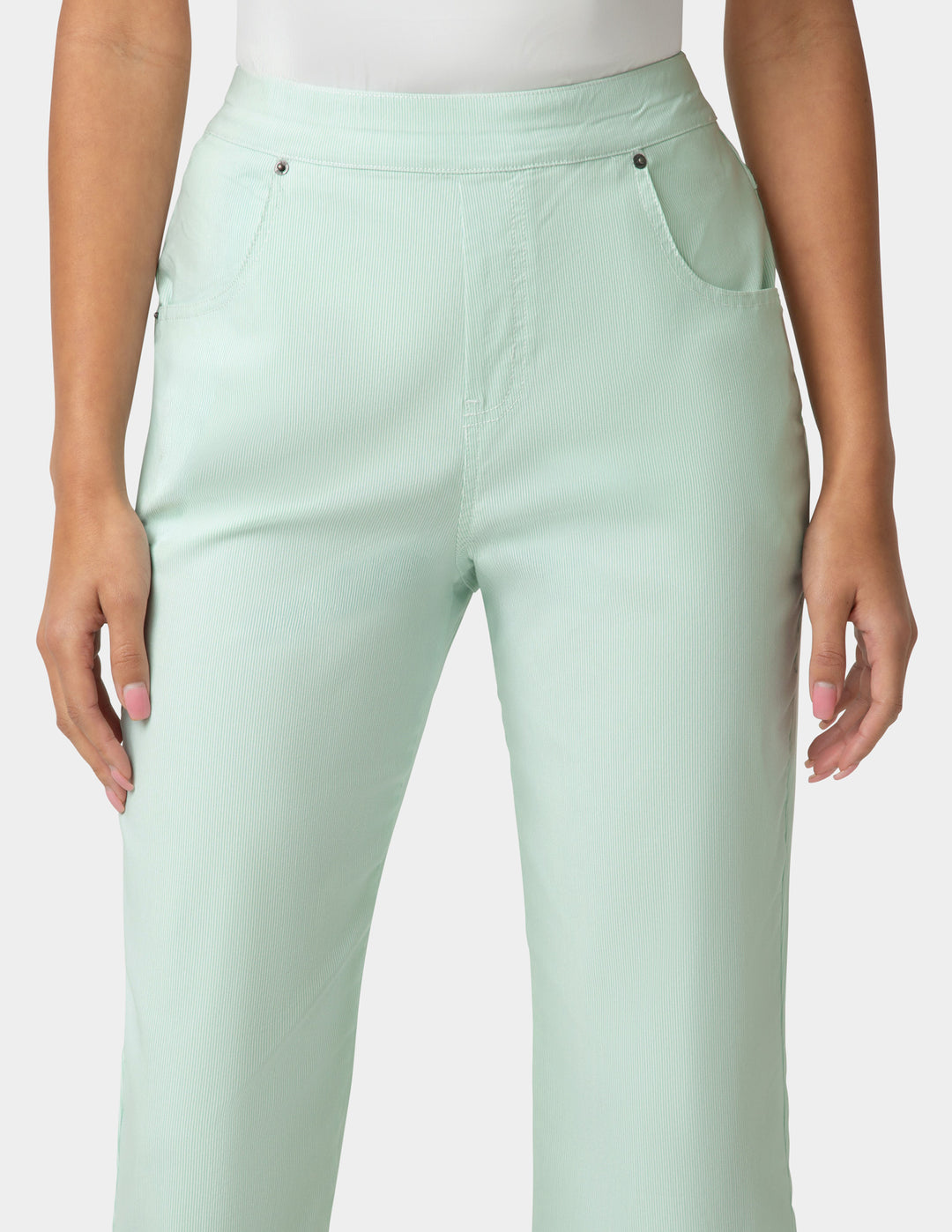 Light green pants worn by a person on a plain background
