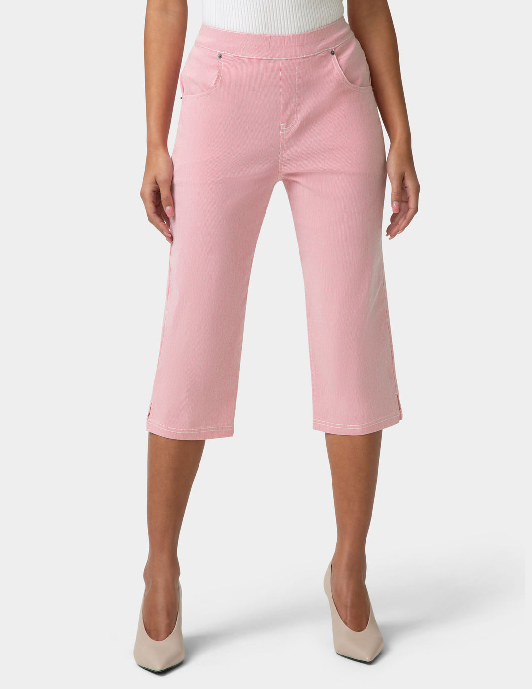 Person wearing pink capri pants on a white background
