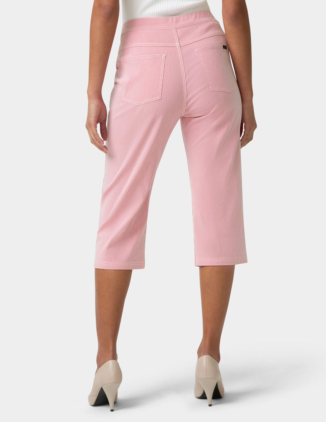 Pink capri pants worn by a person on a white background