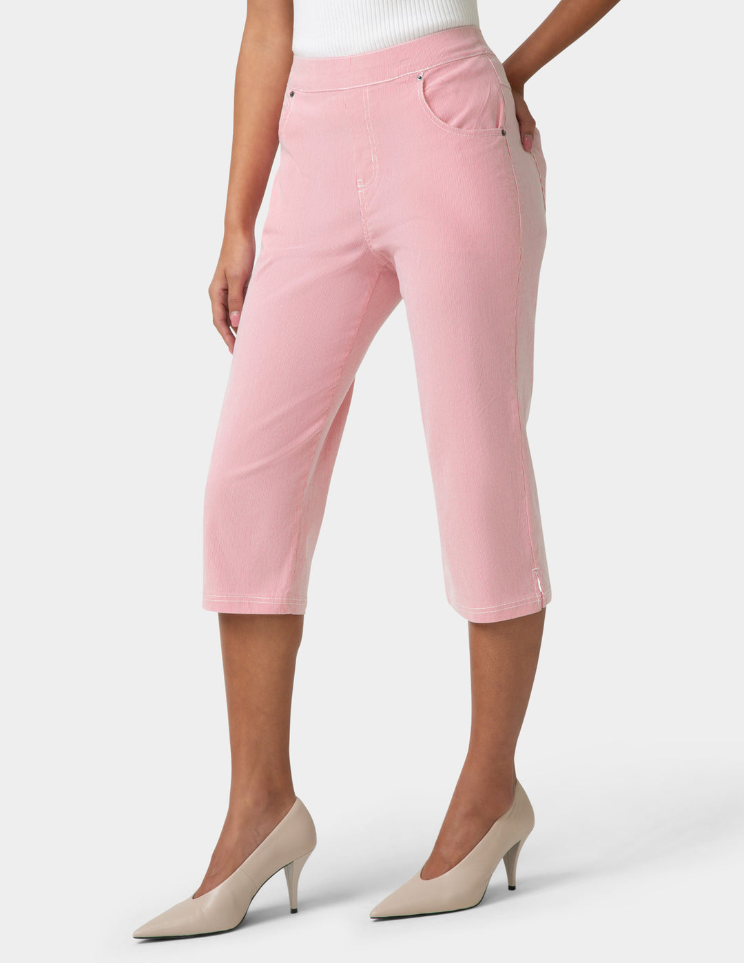Pink capri pants worn by a person on a white background