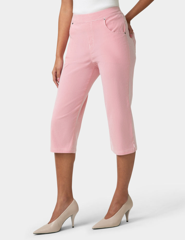 Pink capri pants worn by a person on a white background