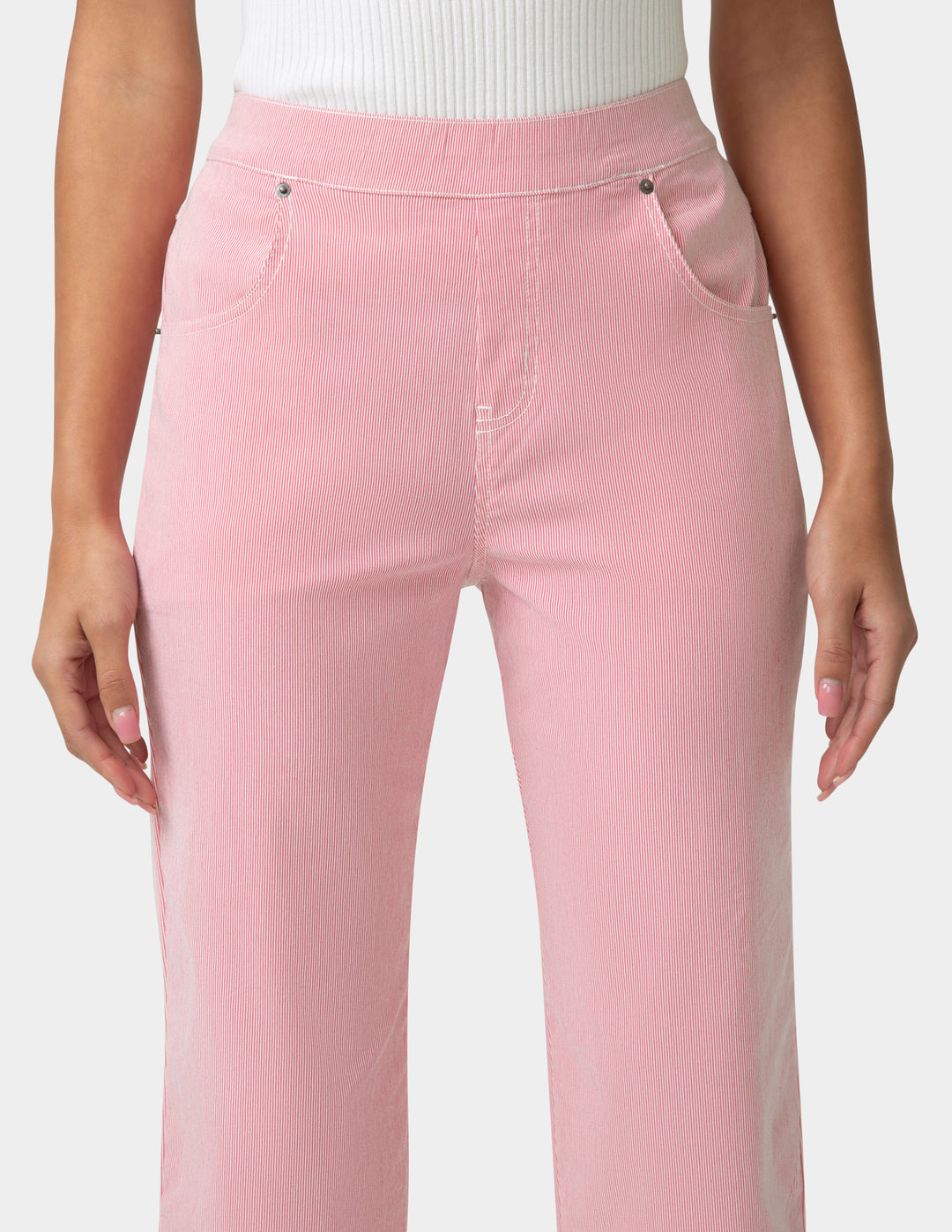 Pink pants worn by a person on a white background