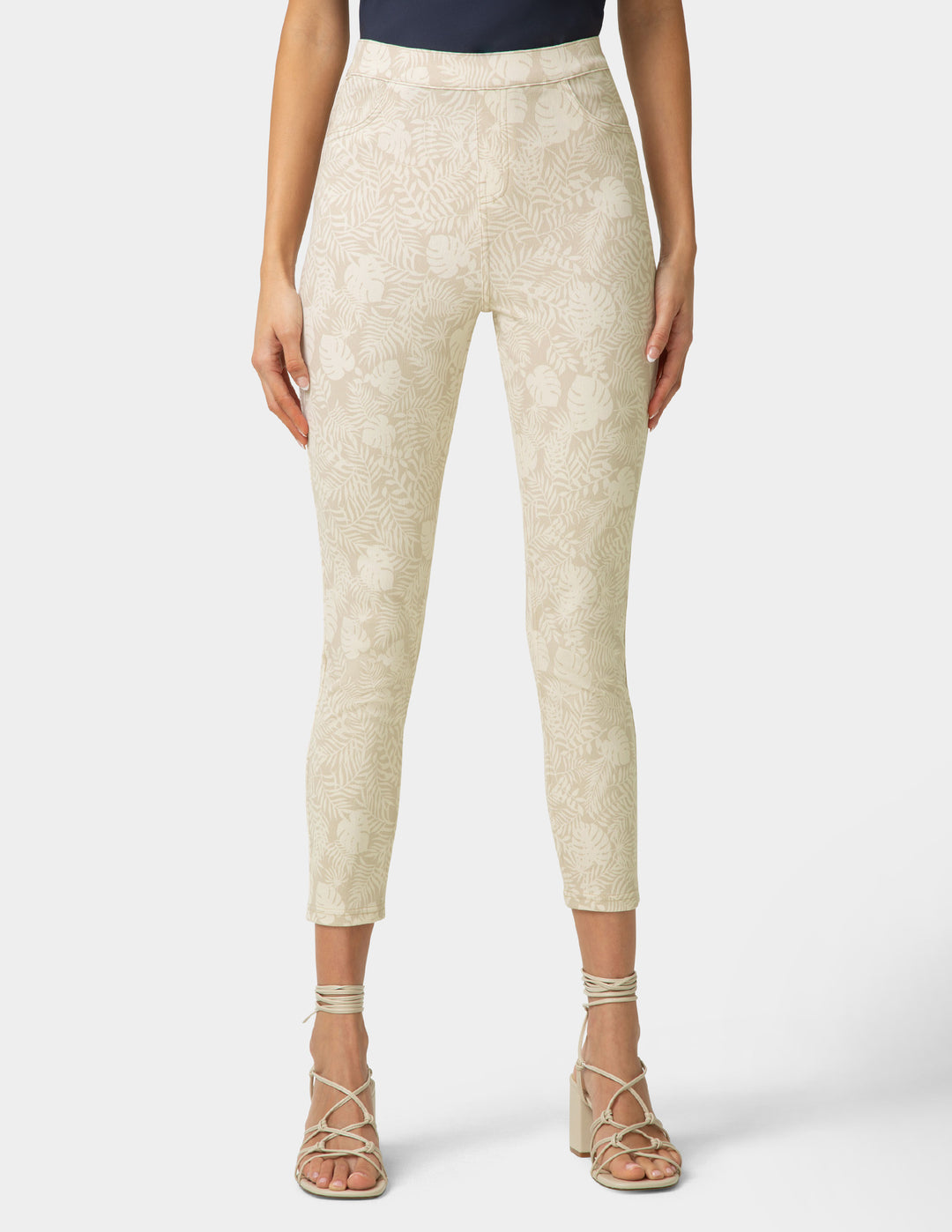 Beige patterned pants worn by a person on a white background