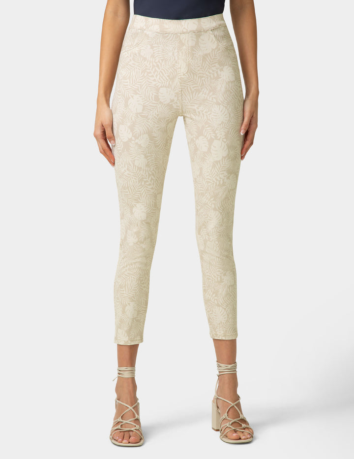 Beige patterned pants worn by a person on a white background