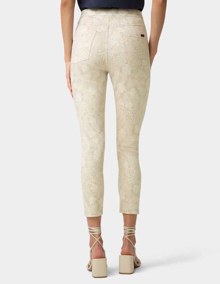 Beige pants worn by a person on a white background