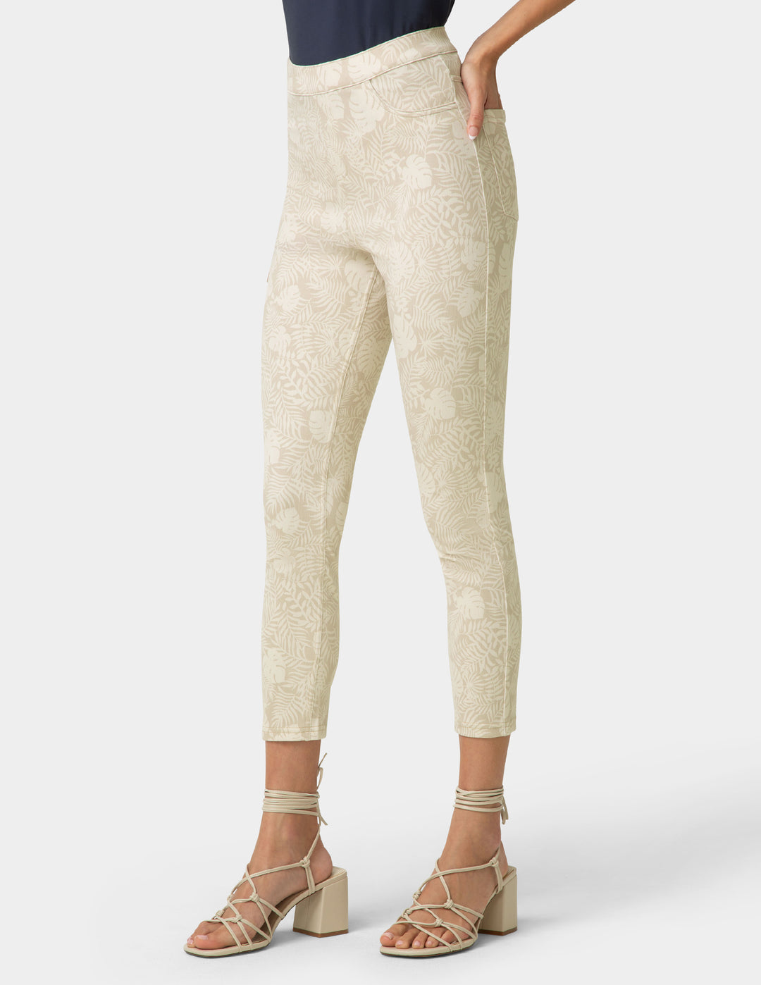 Beige pants worn by a person on a white background