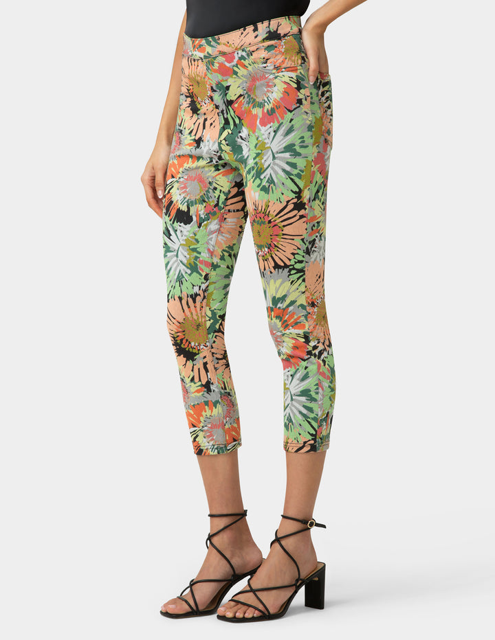 Person wearing colorful floral leggings on a white background