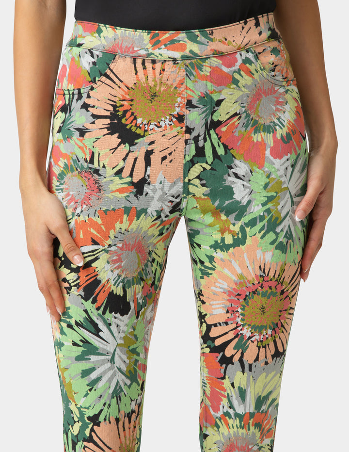 Colorful floral-patterned leggings worn by a person on a white background