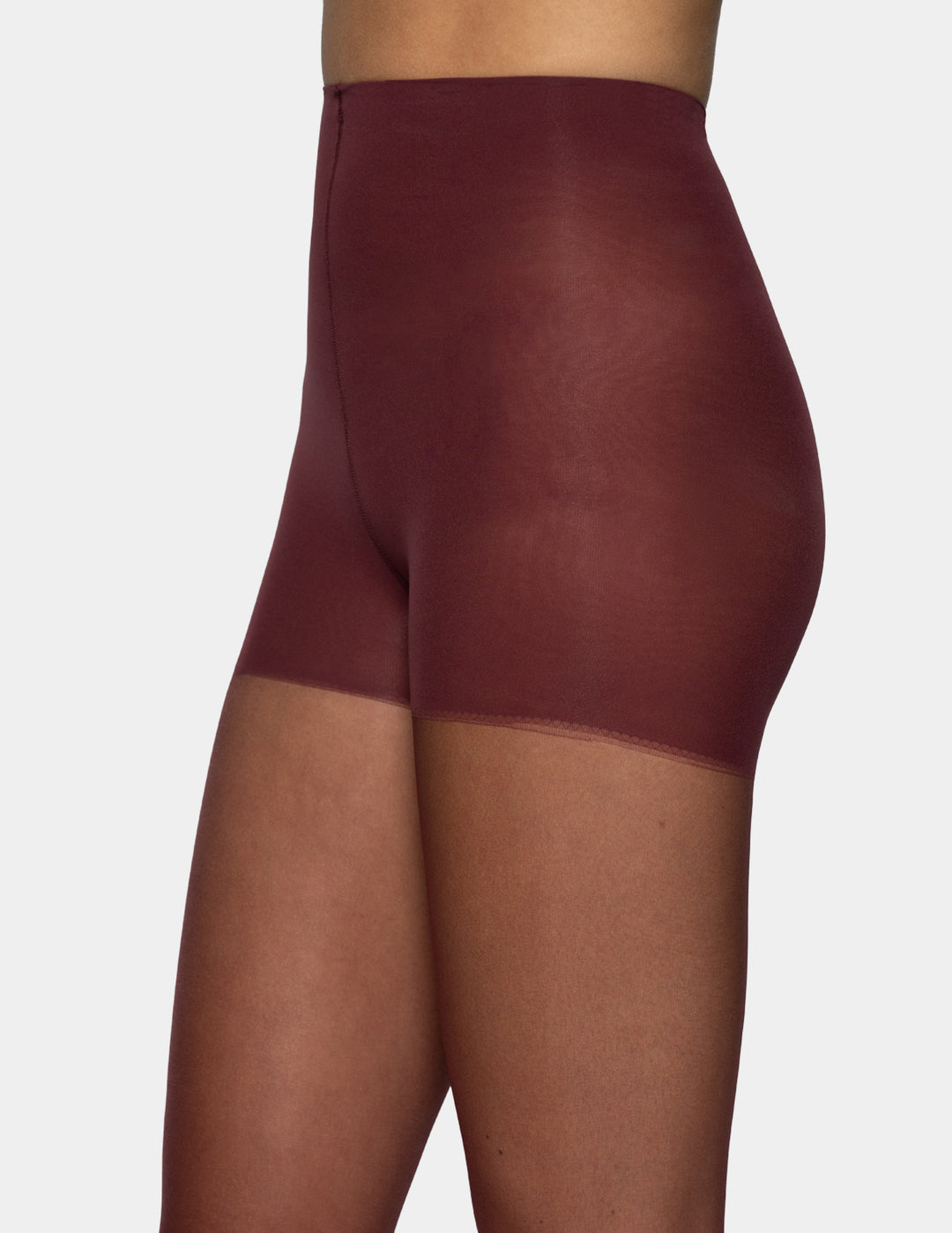 A close-up view of a model wearing sheer burgundy tights set against a plain light gray background.