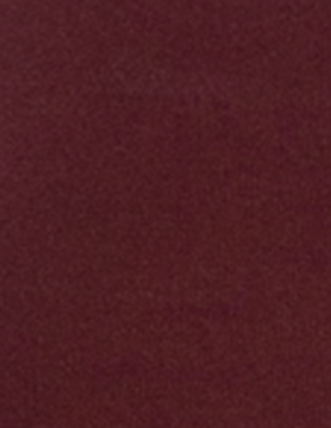 A close-up of a solid dark burgundy fabric texture.