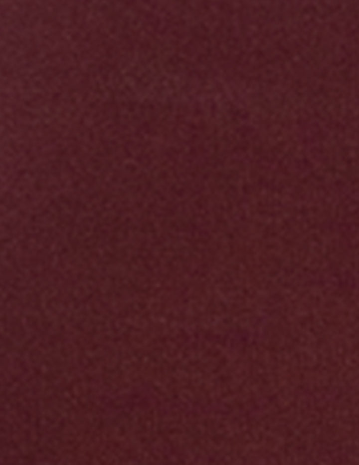 A close-up of a solid dark burgundy fabric texture.