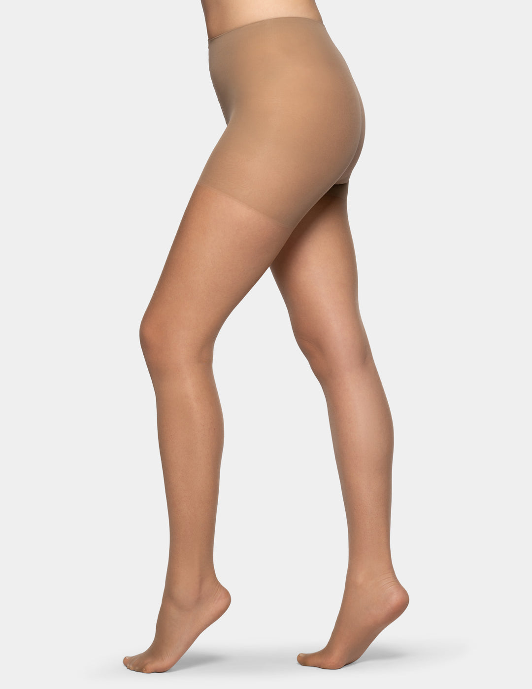 A side view of a model's legs wearing sheer, high-waisted hosiery in a light tan shade, set against a plain light gray background.