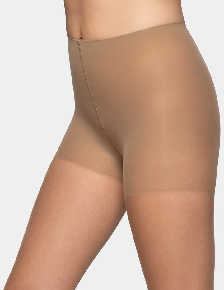Close-up of a model wearing sheer nude high-waisted compression shapewear against a light gray background.