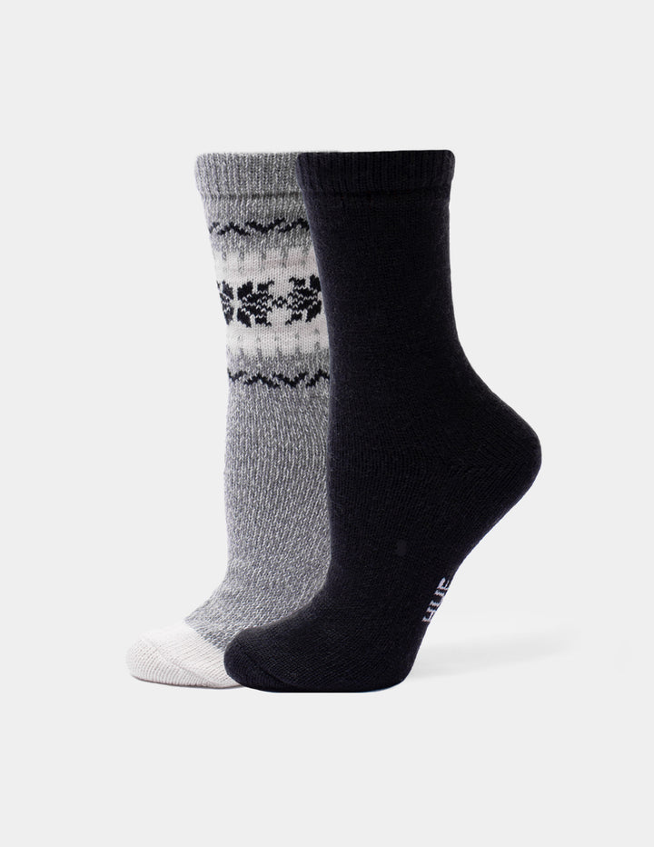 A pair of crew socks shown on invisible forms against a light gray background. One sock is heather gray with a black and white Fair Isle pattern near the cuff and a white toe.
