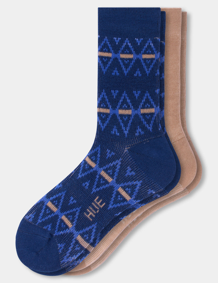 Two crew socks featuring a navy blue and light blue geometric pattern with tan stripes, layered with beige socks on a light gray background.