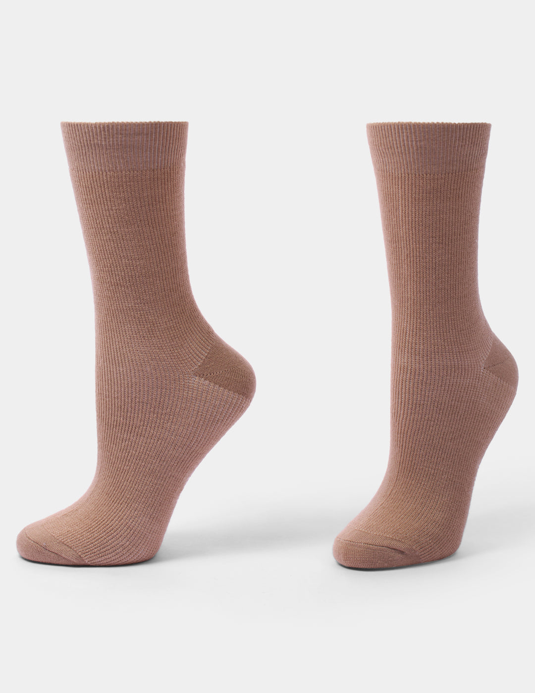 A pair of ribbed crew socks in a tan color, shown from the side on a light gray background.