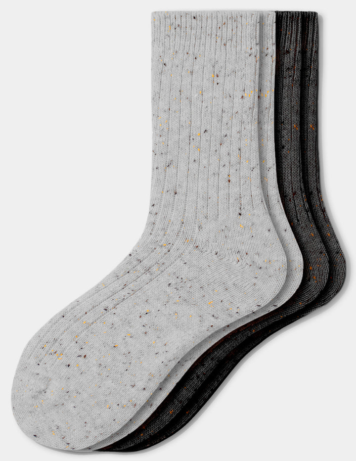 Two pairs of tweed crew socks, one in light grey and one in black, displayed against a light gray background.