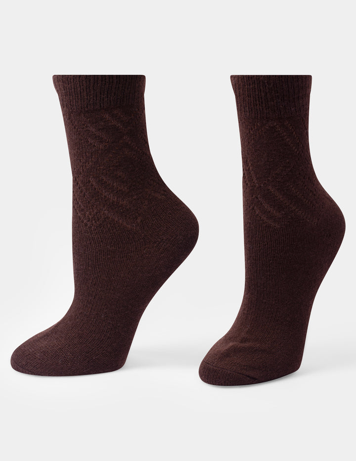 A pair of dark brown crew socks with a subtle textured knit pattern, displayed on a light gray background.
