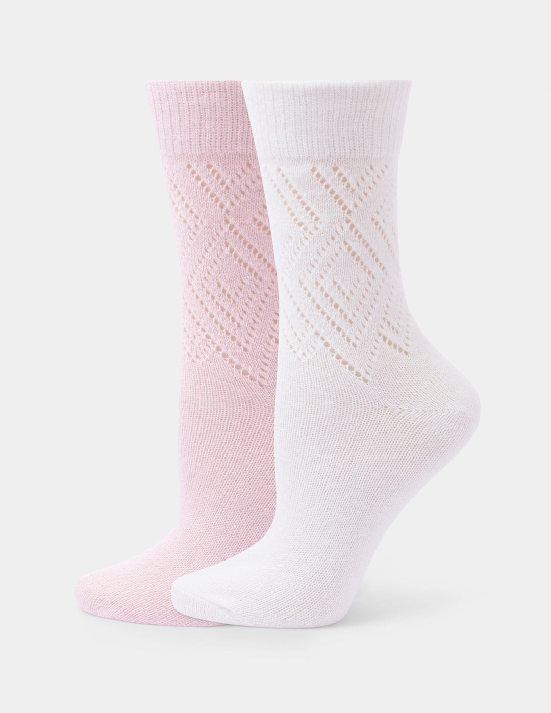 Two crew socks, one light pink and one white, featuring a textured openwork diamond pattern on the upper half and ribbed cuffs, displayed against a light gray background.