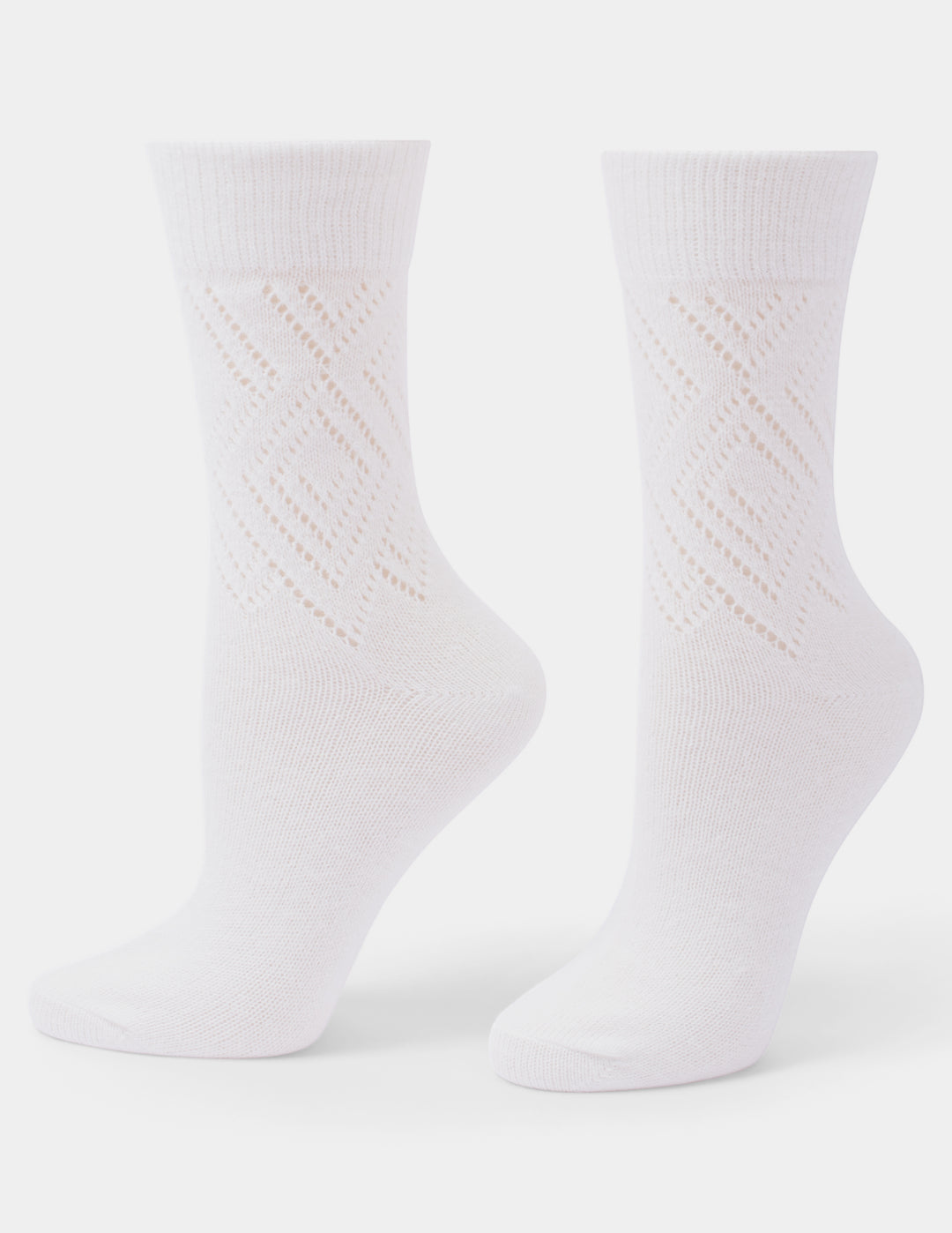 A pair of white crew socks with a textured, openwork diamond pattern on the lower half, displayed on invisible forms against a light gray background.
