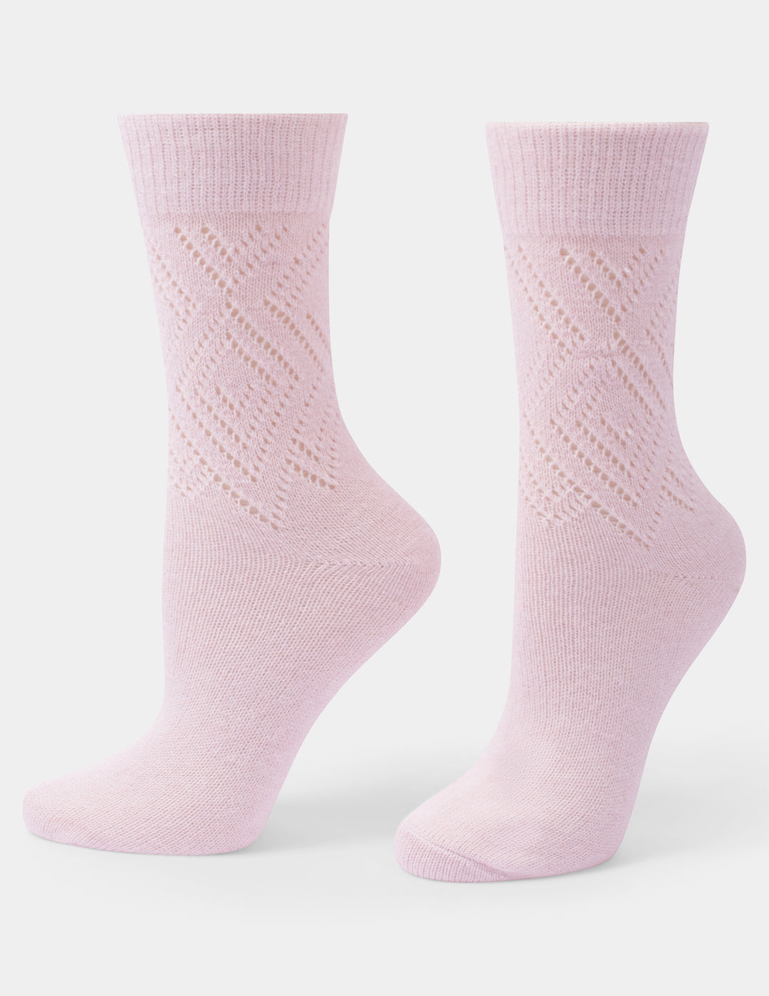 A pair of light pink crew socks with a textured knit pattern on the upper leg, displayed on invisible forms against a clean white background.