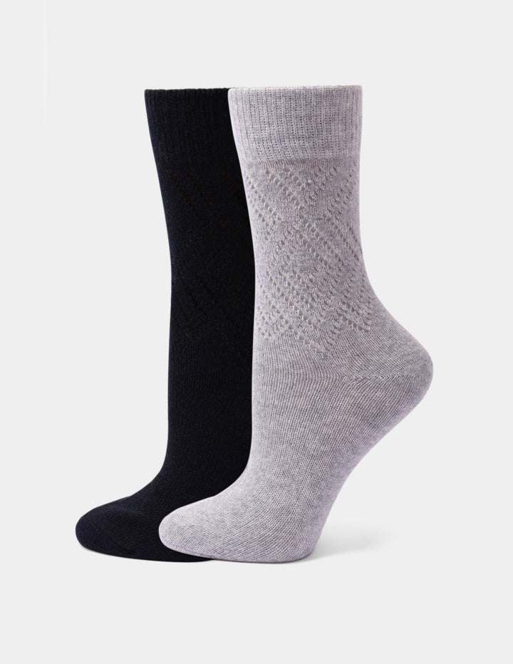 Two crew socks shown on invisible forms against a light gray background. The front sock is light heather gray with a textured knit pattern, and the back sock is solid black.