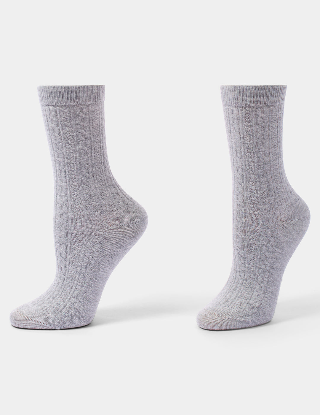 A pair of light gray cable-knit crew socks displayed on invisible forms against a clean white background.