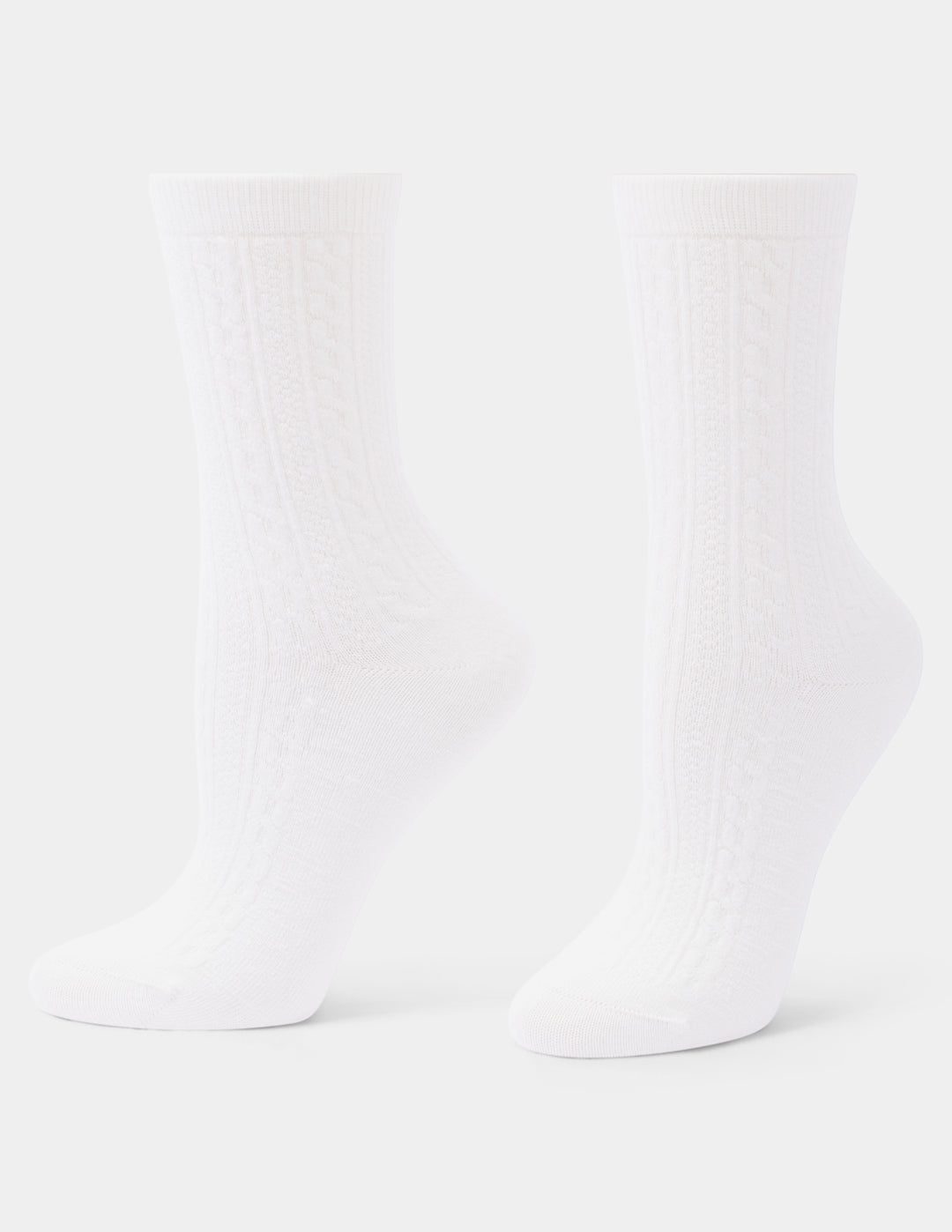 A pair of ivory crew socks with a subtle vertical ribbed texture, shown against a light gray background.