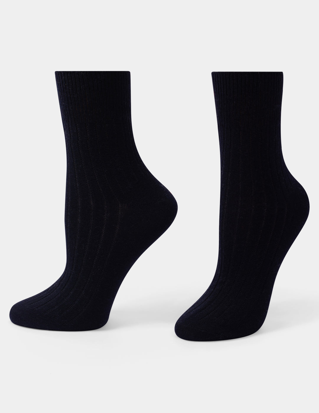 A pair of ribbed ankle socks in black displayed against a clean light gray background.