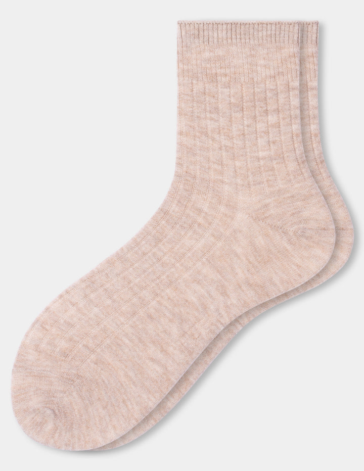 A pair of ribbed ankle socks in a light heathered blush oatmeal color, displayed against a clean light gray background.