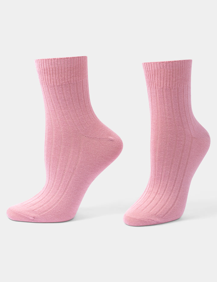 A pair of light pink ribbed ankle socks displayed on invisible forms against a clean, light gray background.