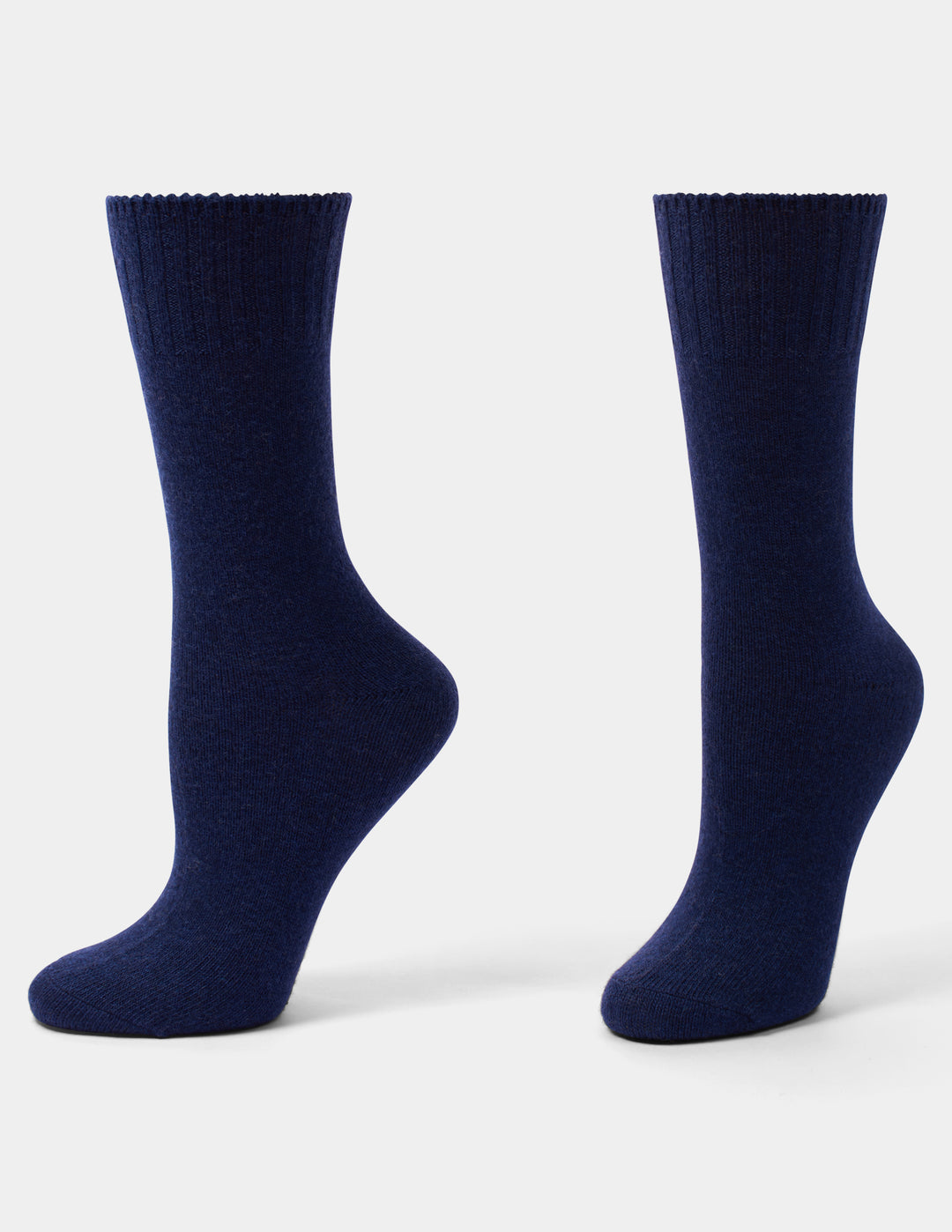 A pair of dark navy blue crew socks shown from the back, standing upright against a light gray studio background.