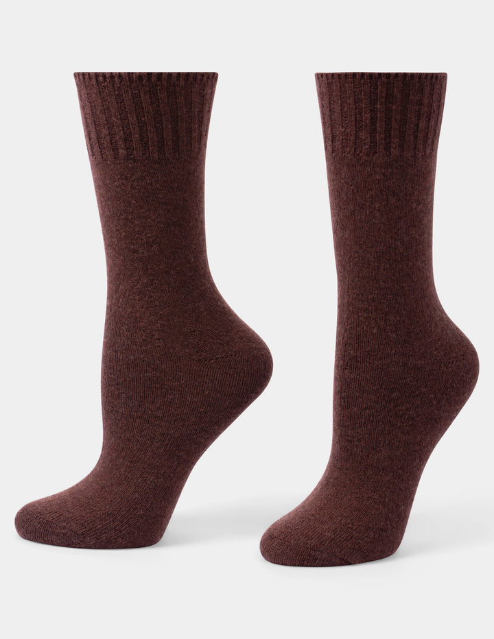 A pair of dark brown ribbed crew socks displayed on invisible forms against a light gray background.