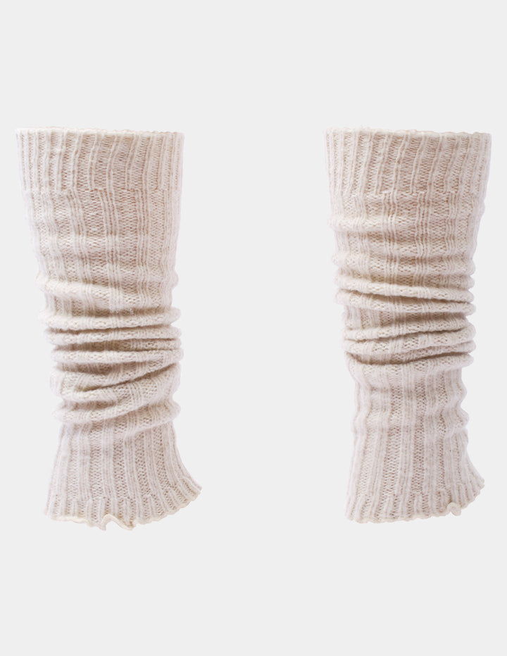 Ribbed light beige leg warmers photographed against a light gray background.