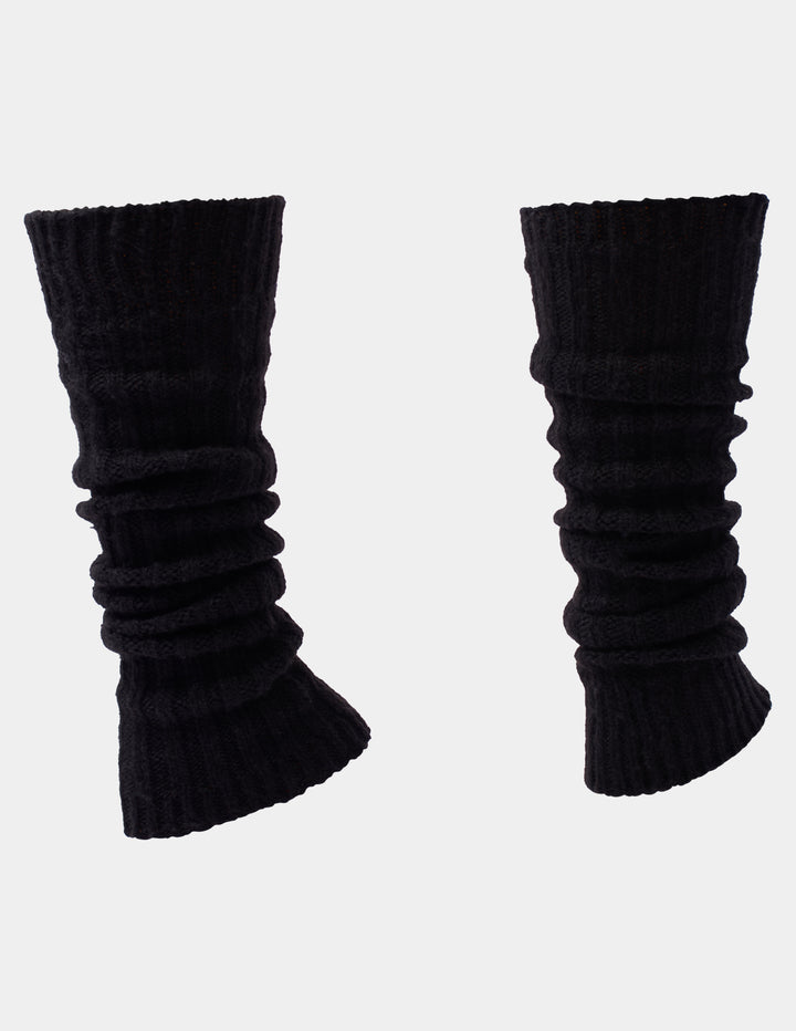 Ribbed black leg warmers photographed against a light gray background.