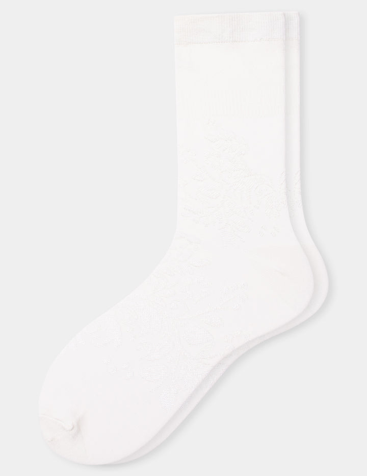 A pair of ivory crew socks with a floral textured pattern, shown against a light gray background.