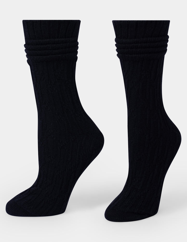Pair of black socks on a grey background