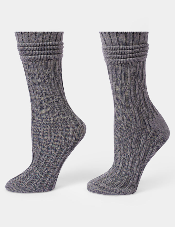 A pair of dark gray ribbed knit crew socks shown from the side against a light gray background.