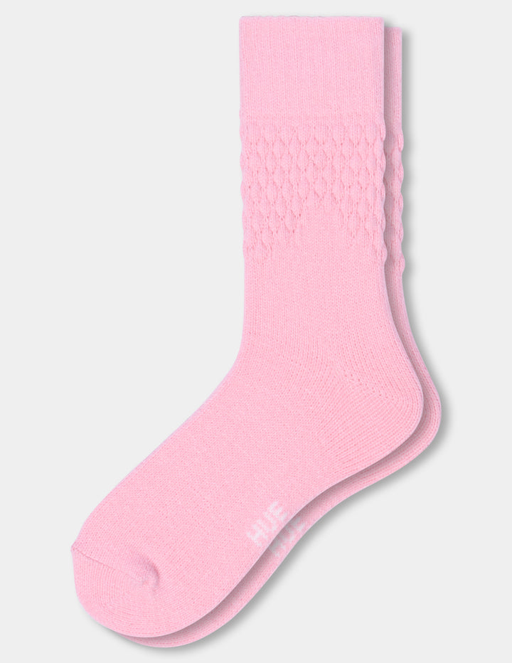A pair of pink textured crew socks against a light gray background.