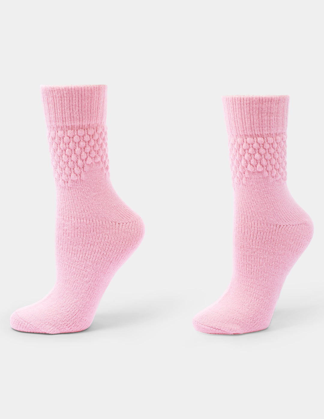 A pair of pink textured crew socks against a light gray background.