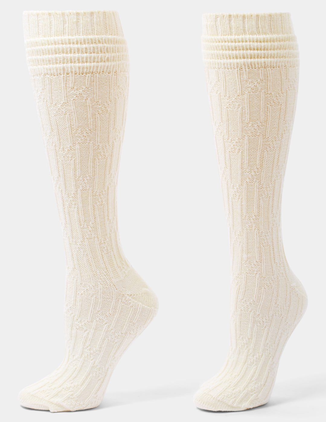 A pair of ivory cable knee socks against a light gray background. 