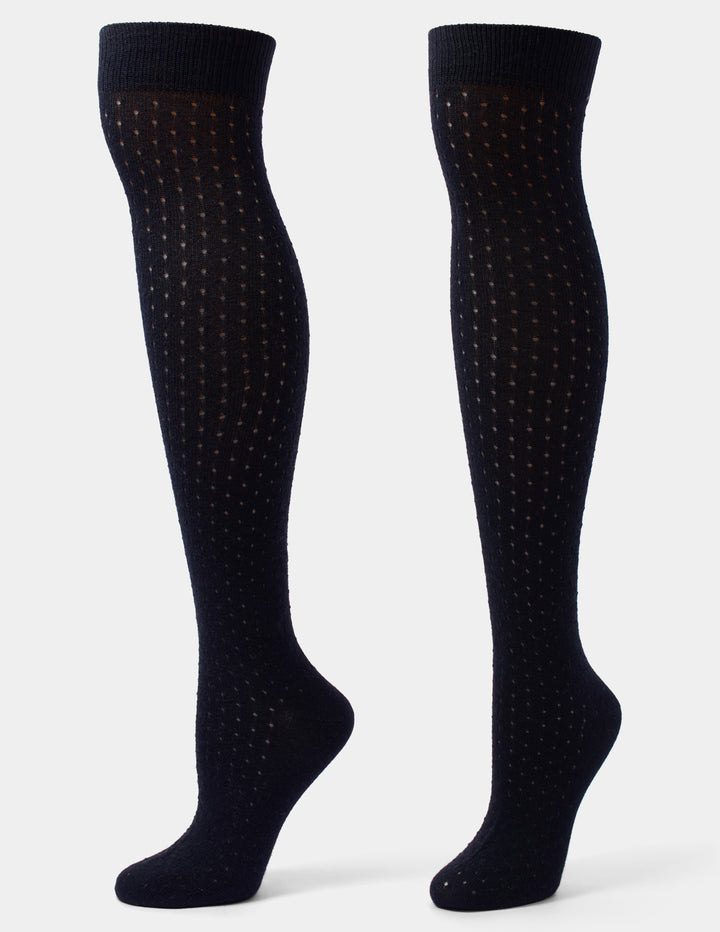 A pair of black over-the-knee socks with a textured, dotted knit pattern, displayed on invisible forms against a light gray background.
