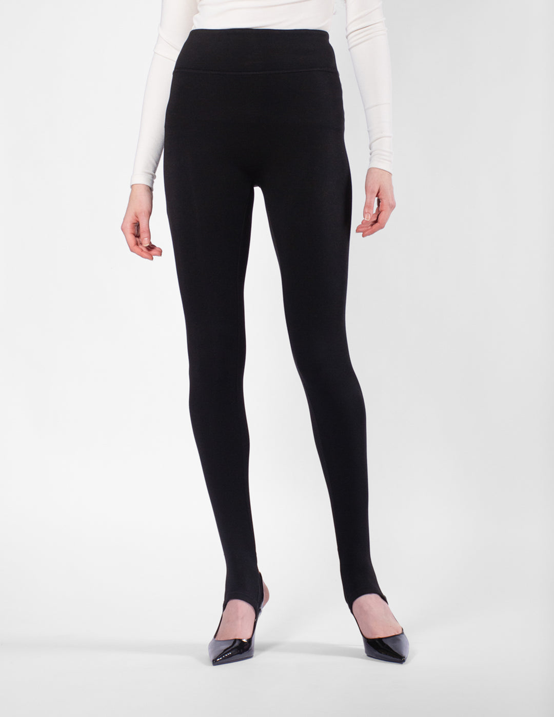 Person wearing black leggings on a white background