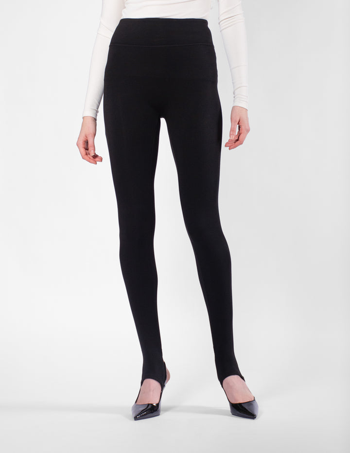 Person wearing black leggings on a white background