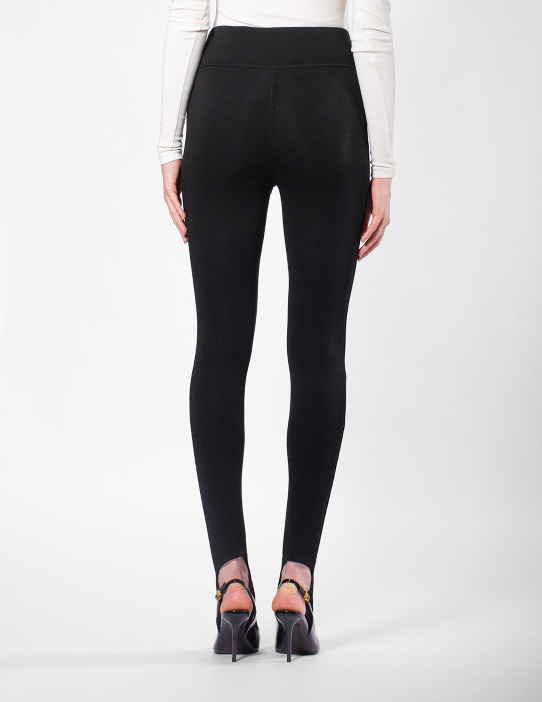 Black leggings worn by a person on a white background
