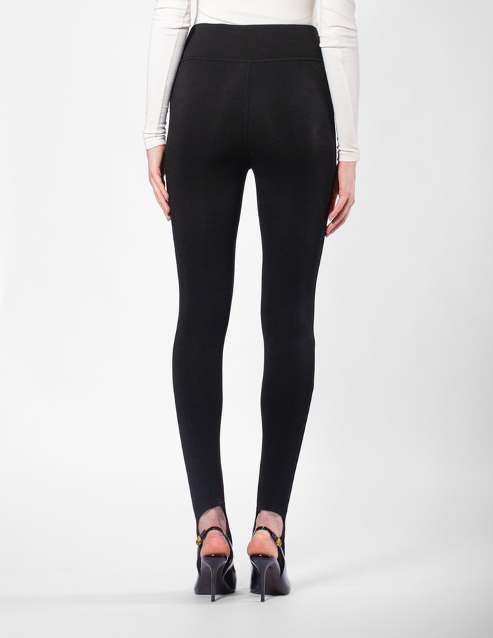 Black leggings worn by a person on a white background