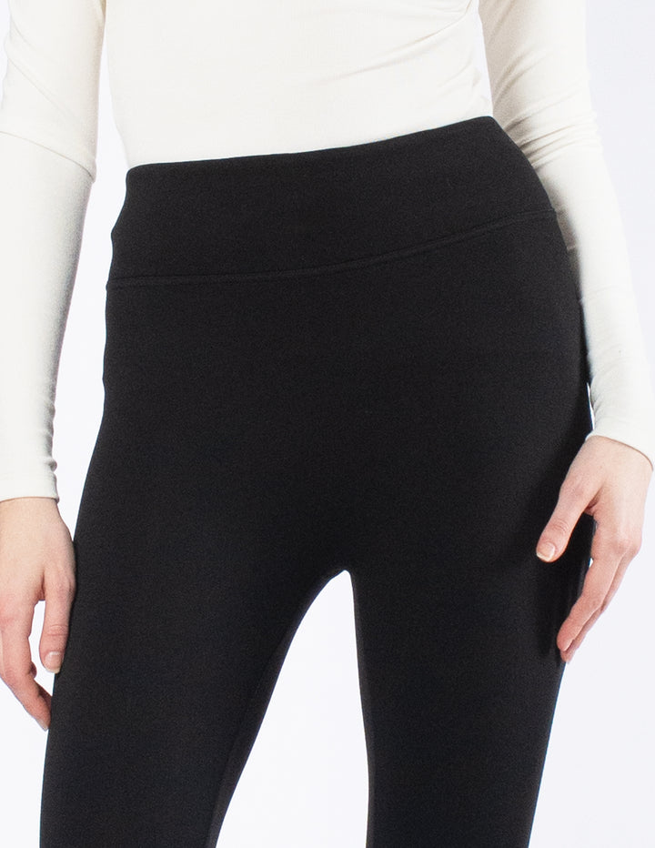 Black leggings worn by a person on a white background