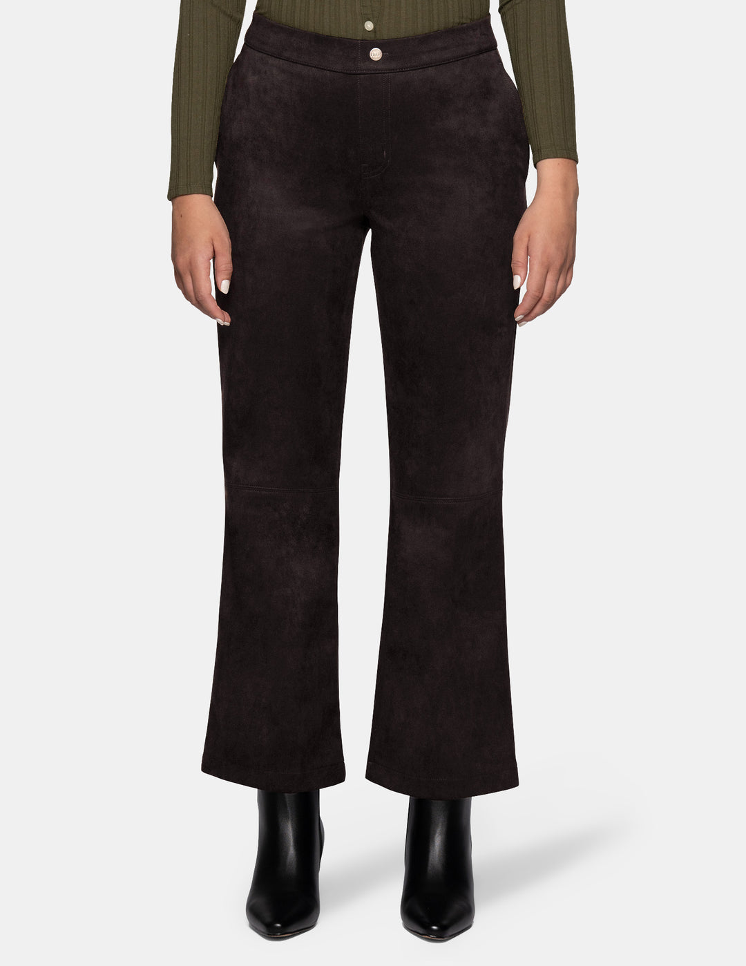 A model wearing dark brown suede flare pants paired with a long sleeve olive top and black boots, photographed against a light grey background.