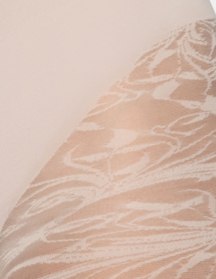 Close-up of a sheer nude lace or mesh fabric with an allover tonal floral or abstract vine pattern, shown against a matching nude background.